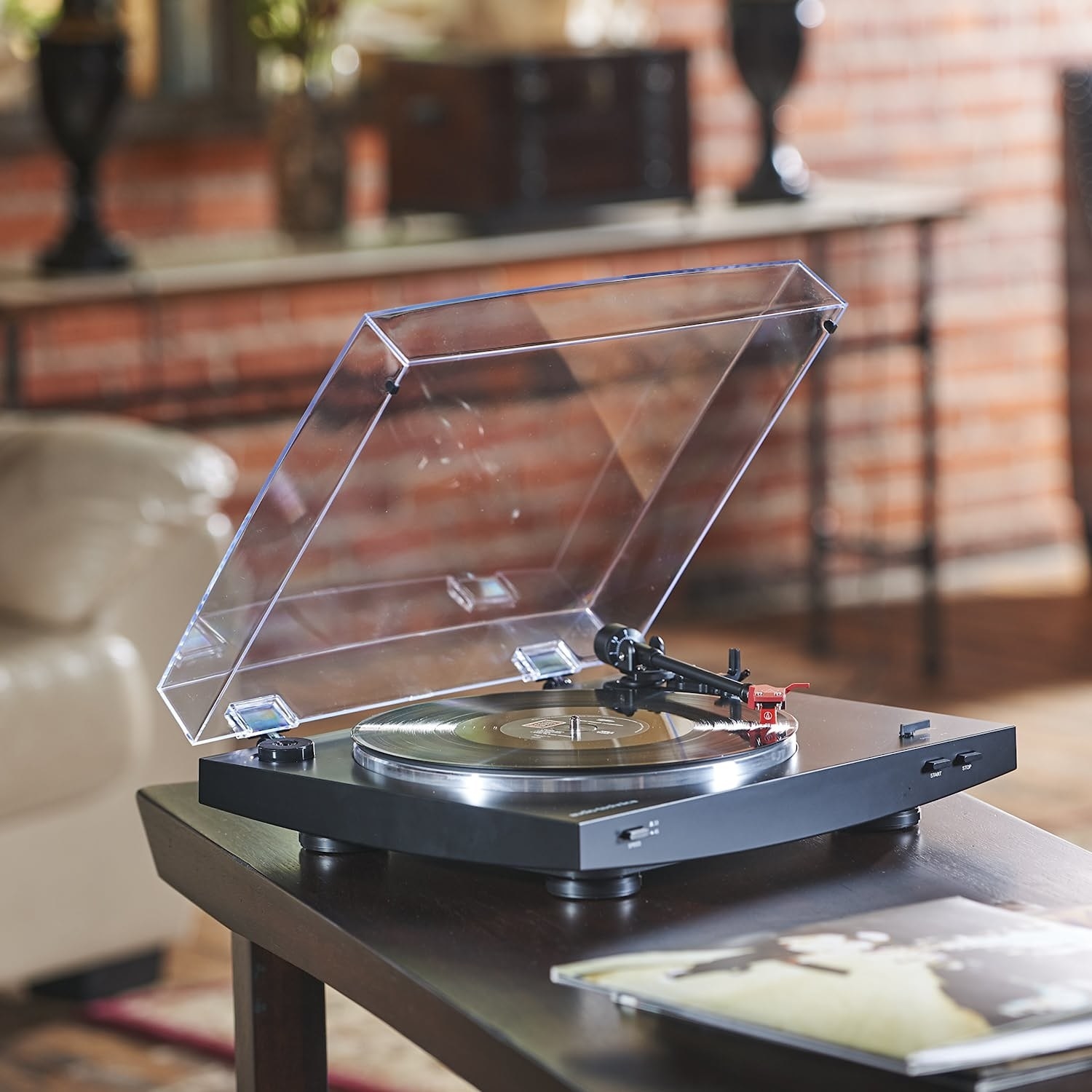 THe record player with black base and clear lid