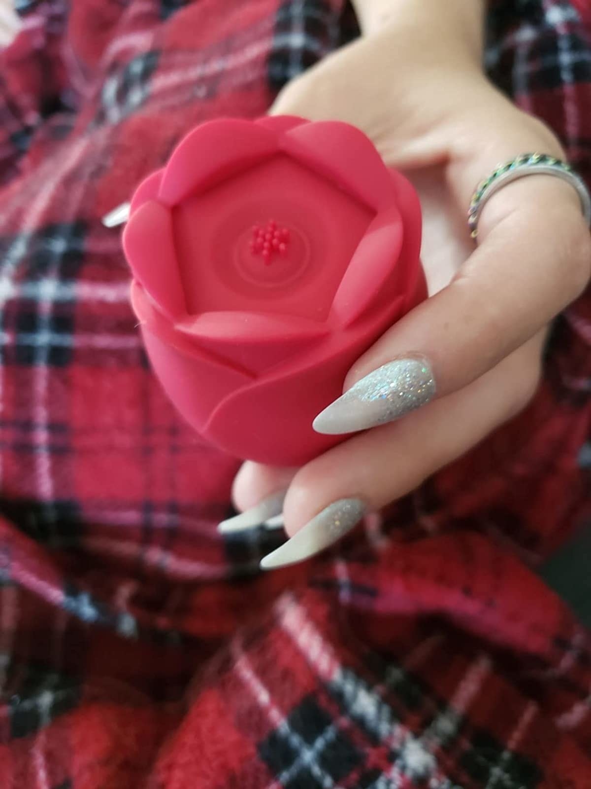 Reviewer holding red rose vibrator