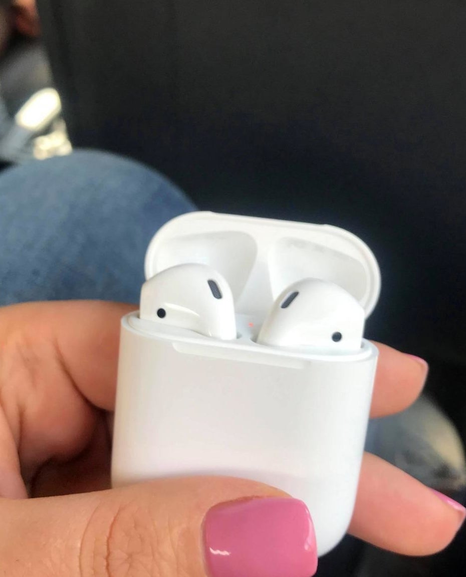 Reviewer holding airpods