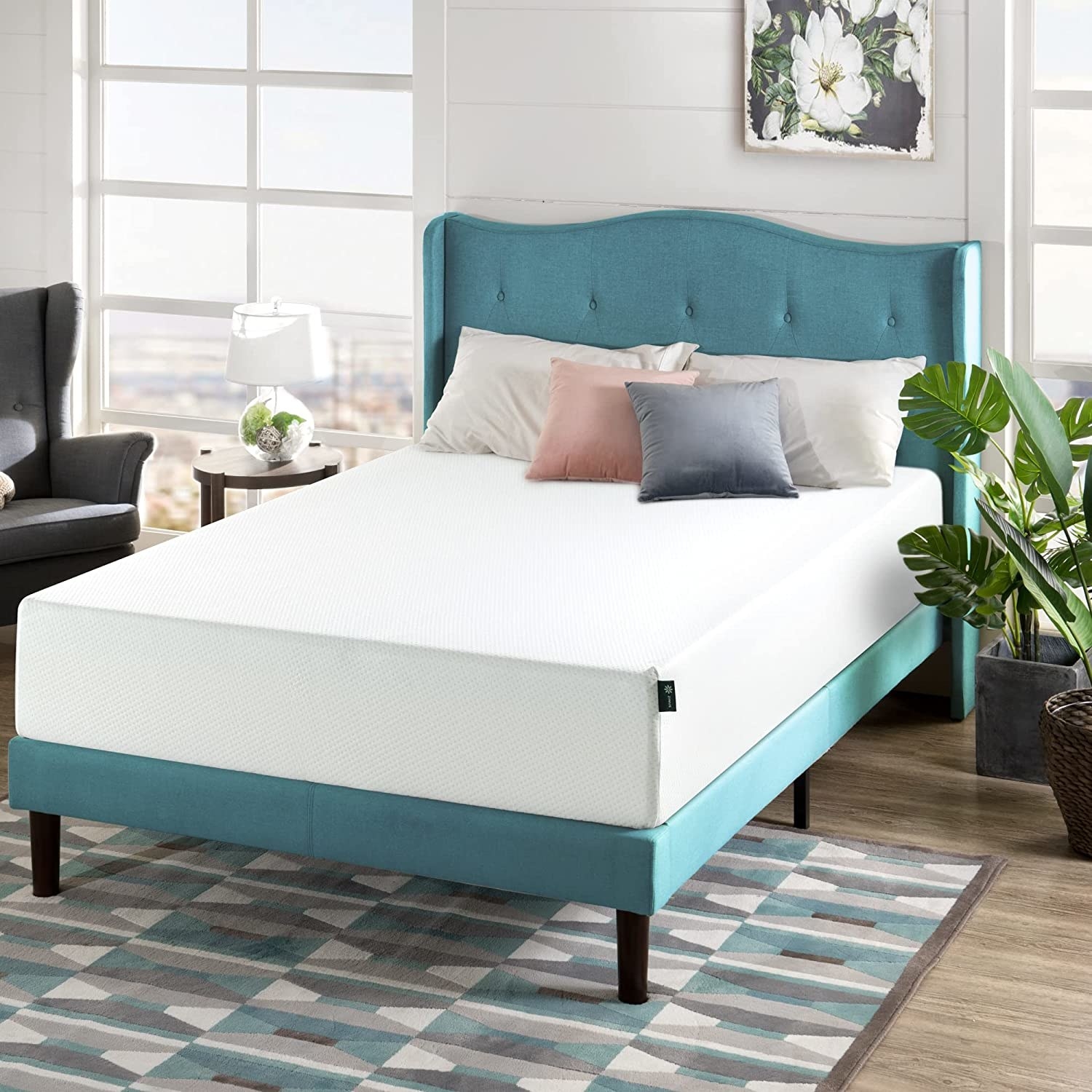 the white mattress on a teal bed frame