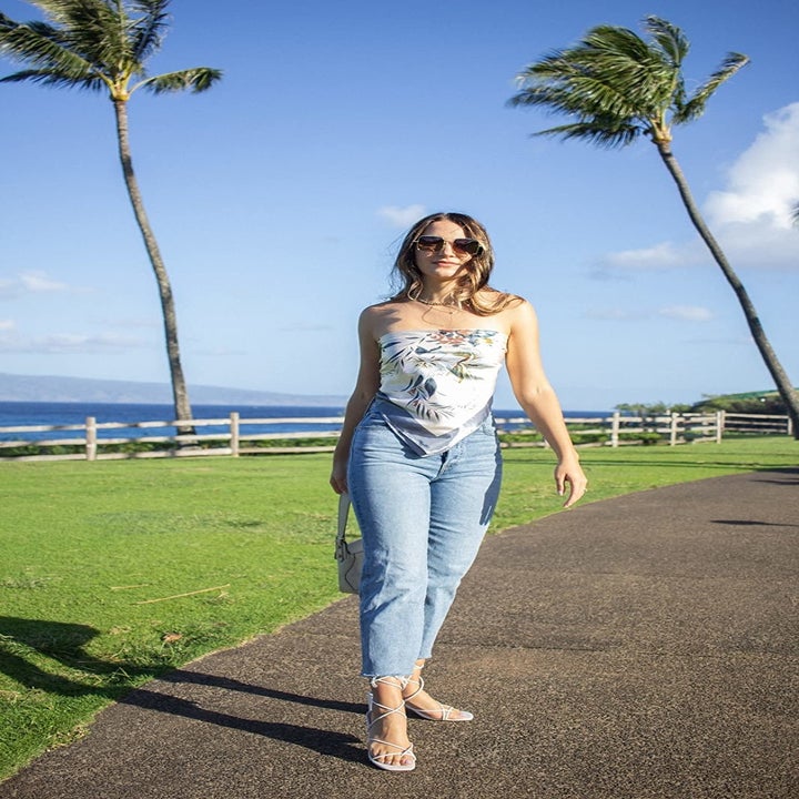 another reviewer wearing the medium wash version with a tube top