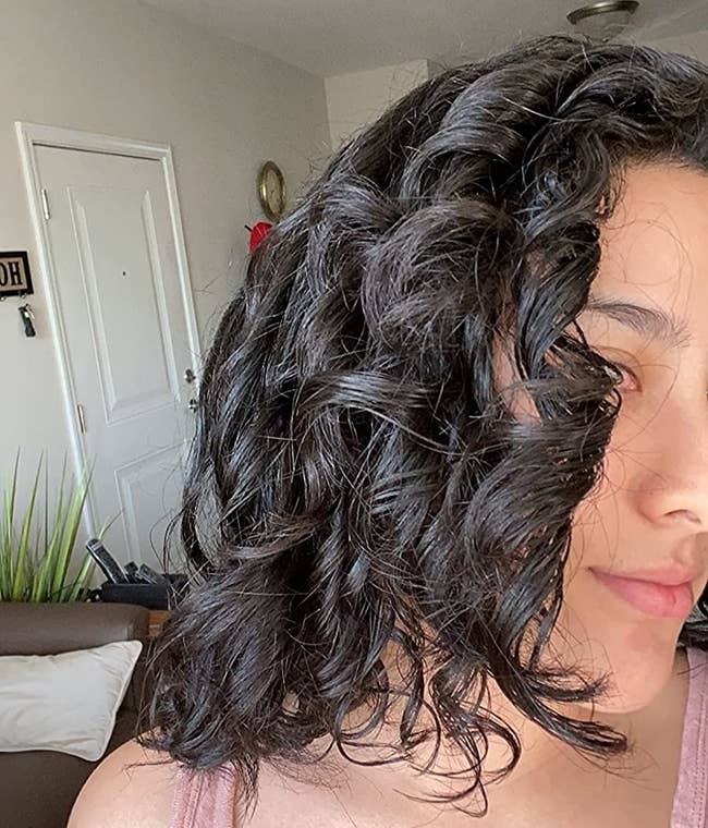 reviewer with soft, shiny, and full-looking curls after using olaplex
