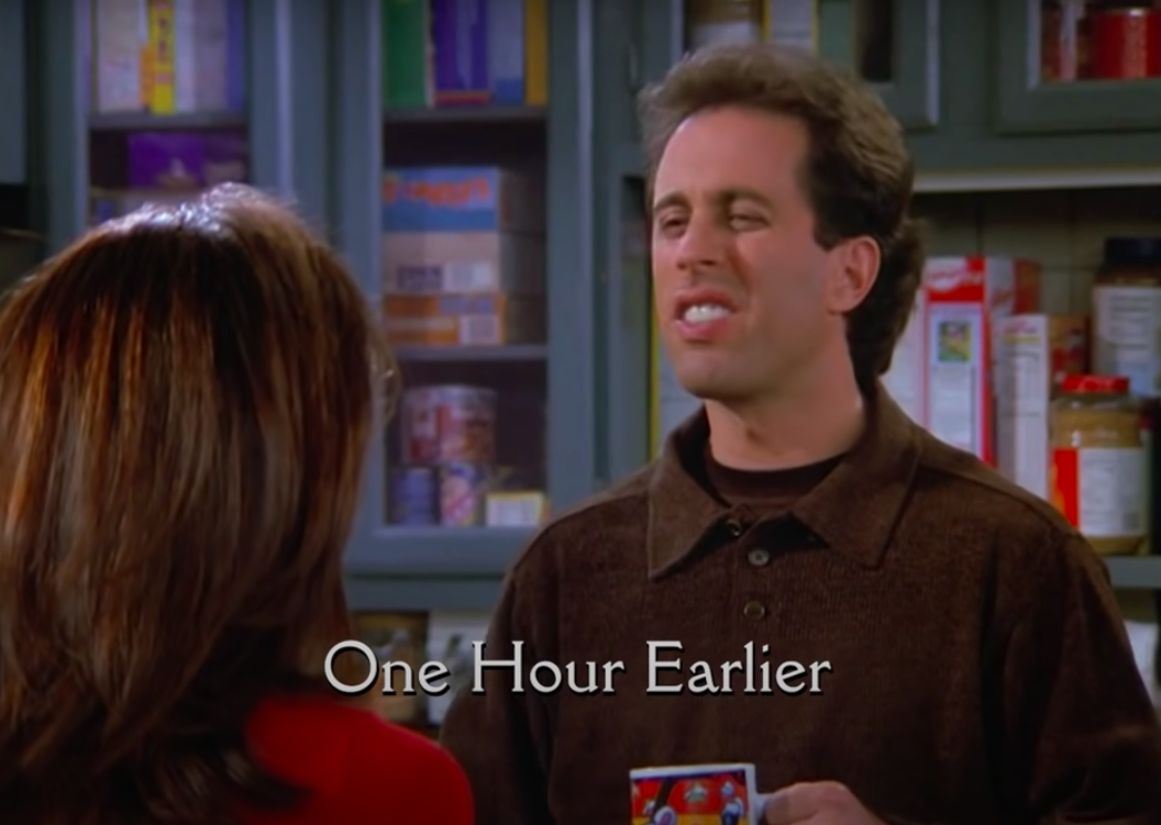 closeup of Seinfeld in his home with text, &quot;one hour earlier,&quot; on the bottom of the screen