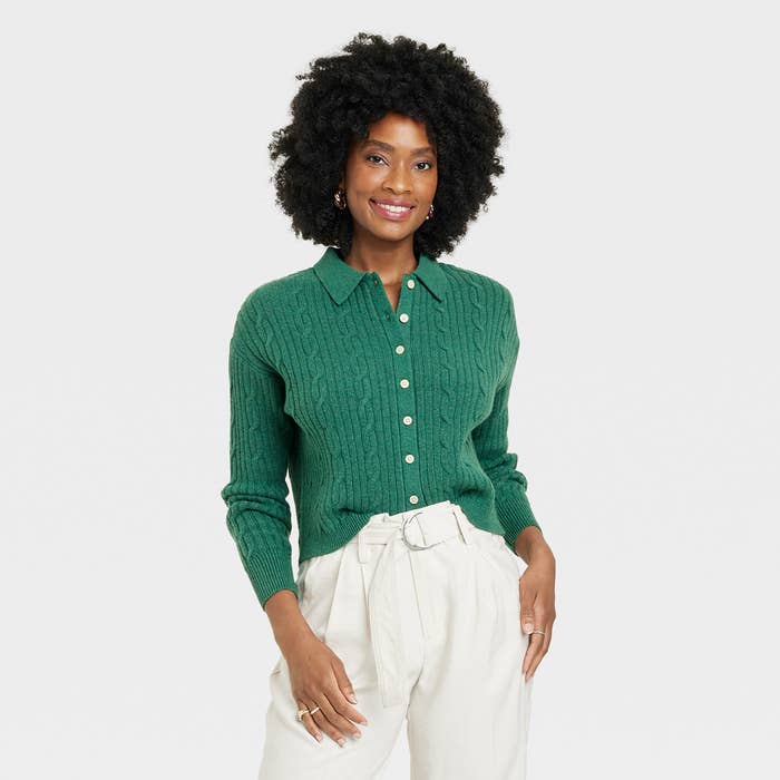 Beautiful woman smiles while wearing cozy cardigan and comfortable belted pants