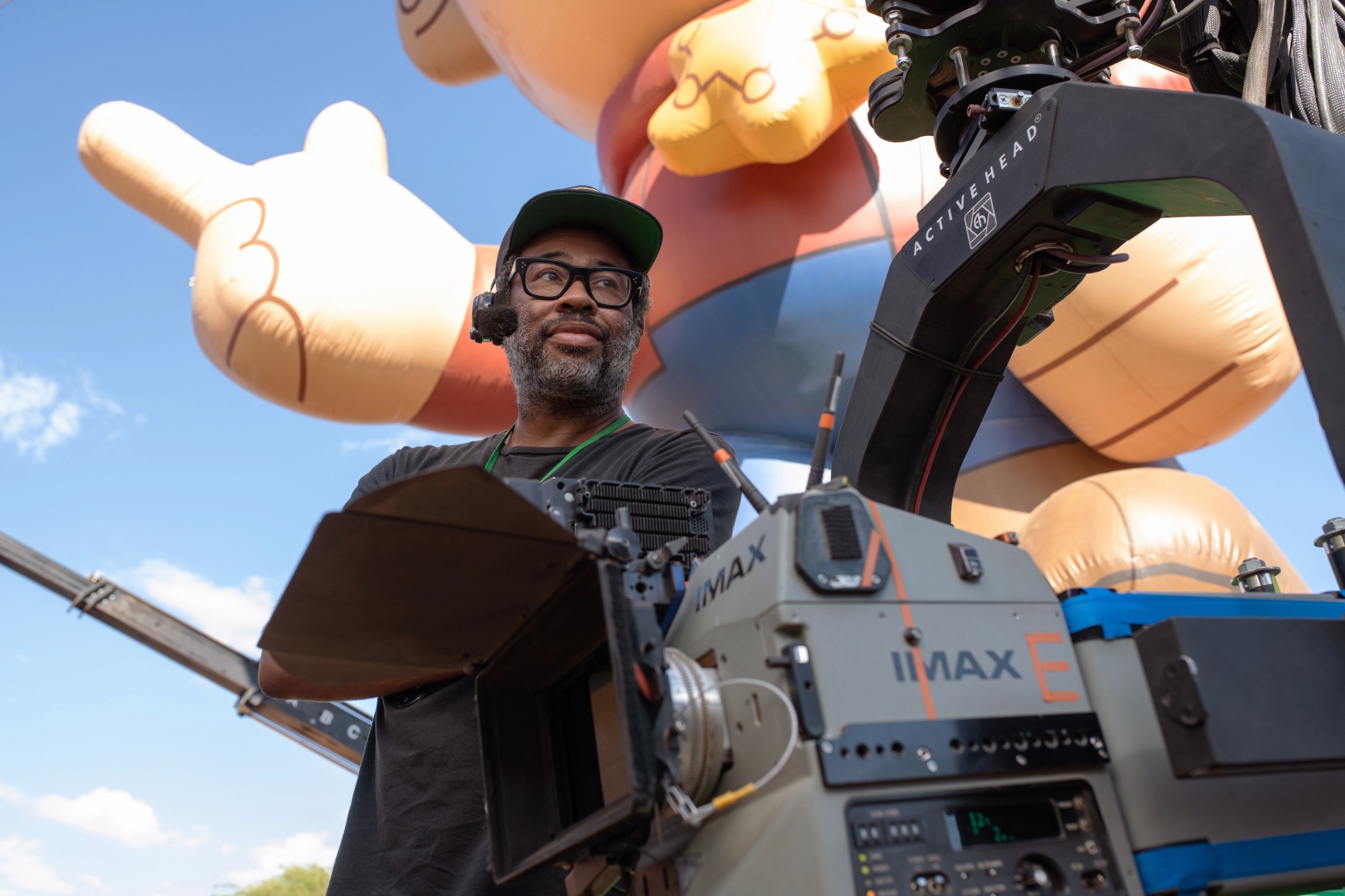 A man stands on set directing