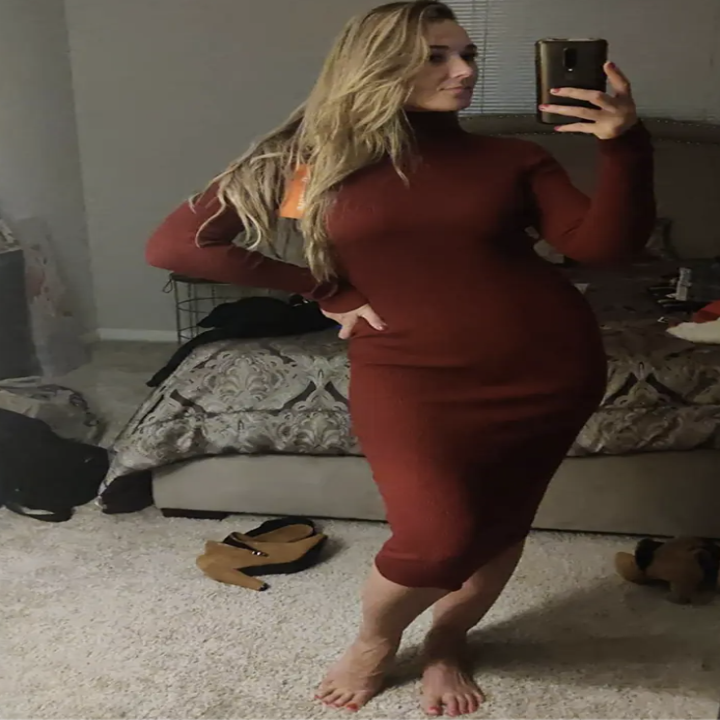 reviewer wearing red turtleneck midi dress in a mirror selfie