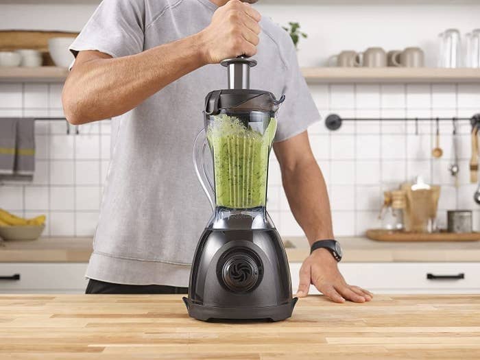 a person using the vitamix blender