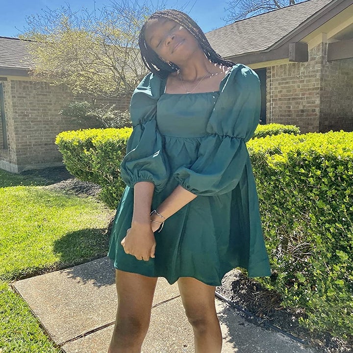 reviewer wearing the green dress