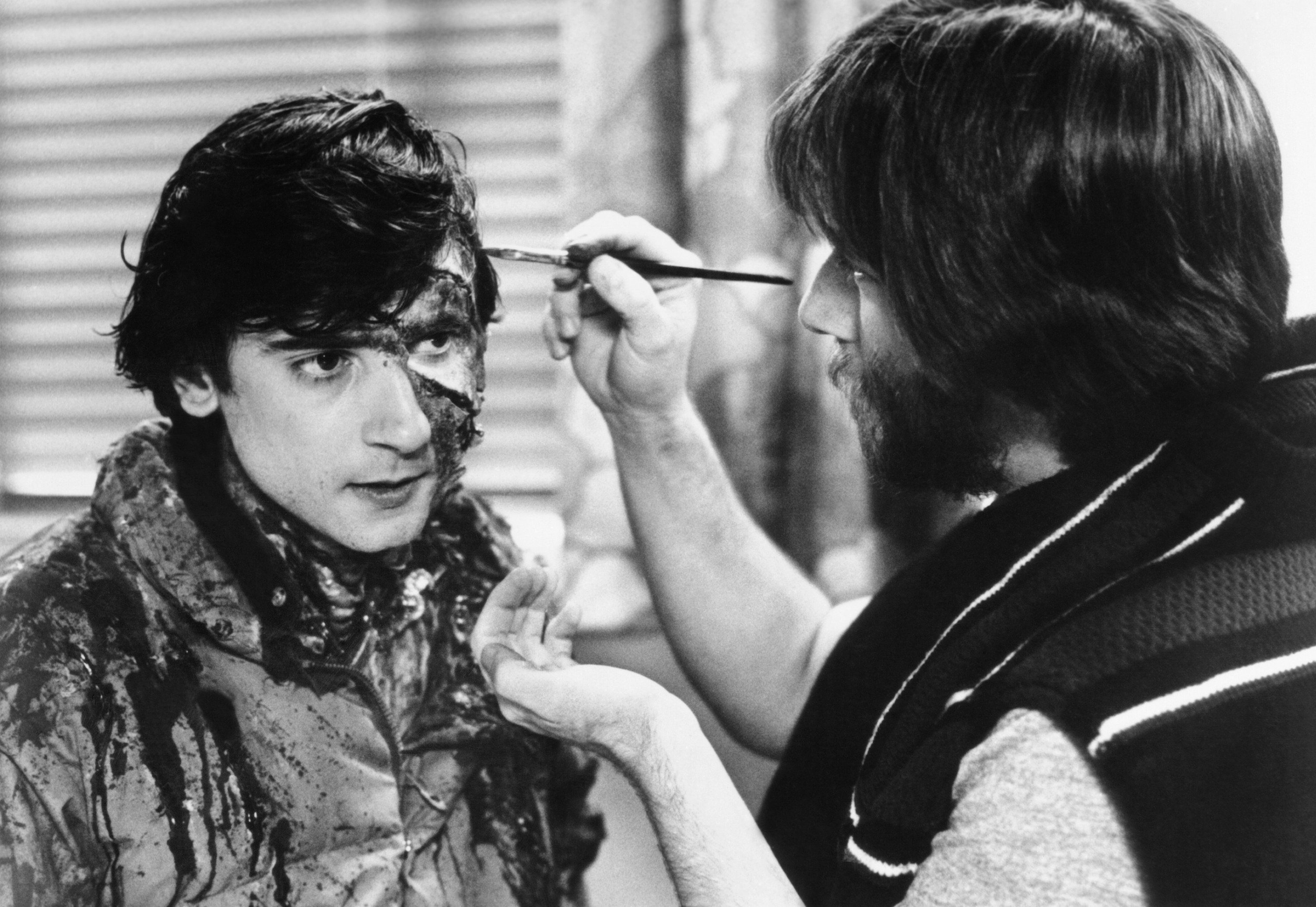 Rick Baker, right, applies makeup to Griffin Dunne, on-set