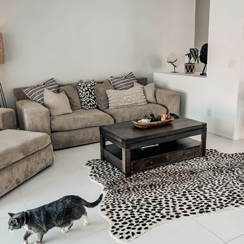 reviewer's leopard print faux hide rug in minimalist living room