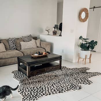 reviewer's leopard print faux hide rug in minimalist living room