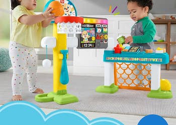 two children playing with the basketball hoope set and snack stand