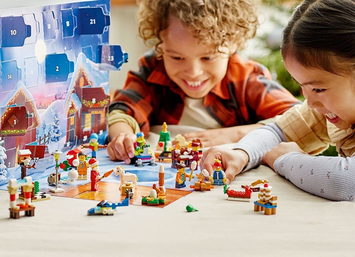two children playing with the wintry lego advent calendar