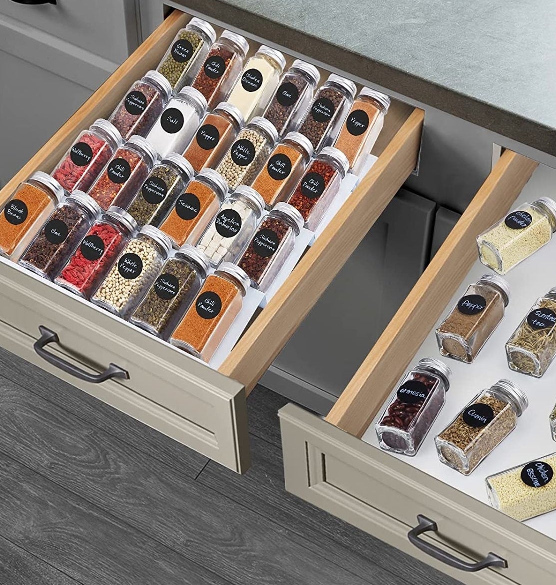 a tiered spice rack in a drawer