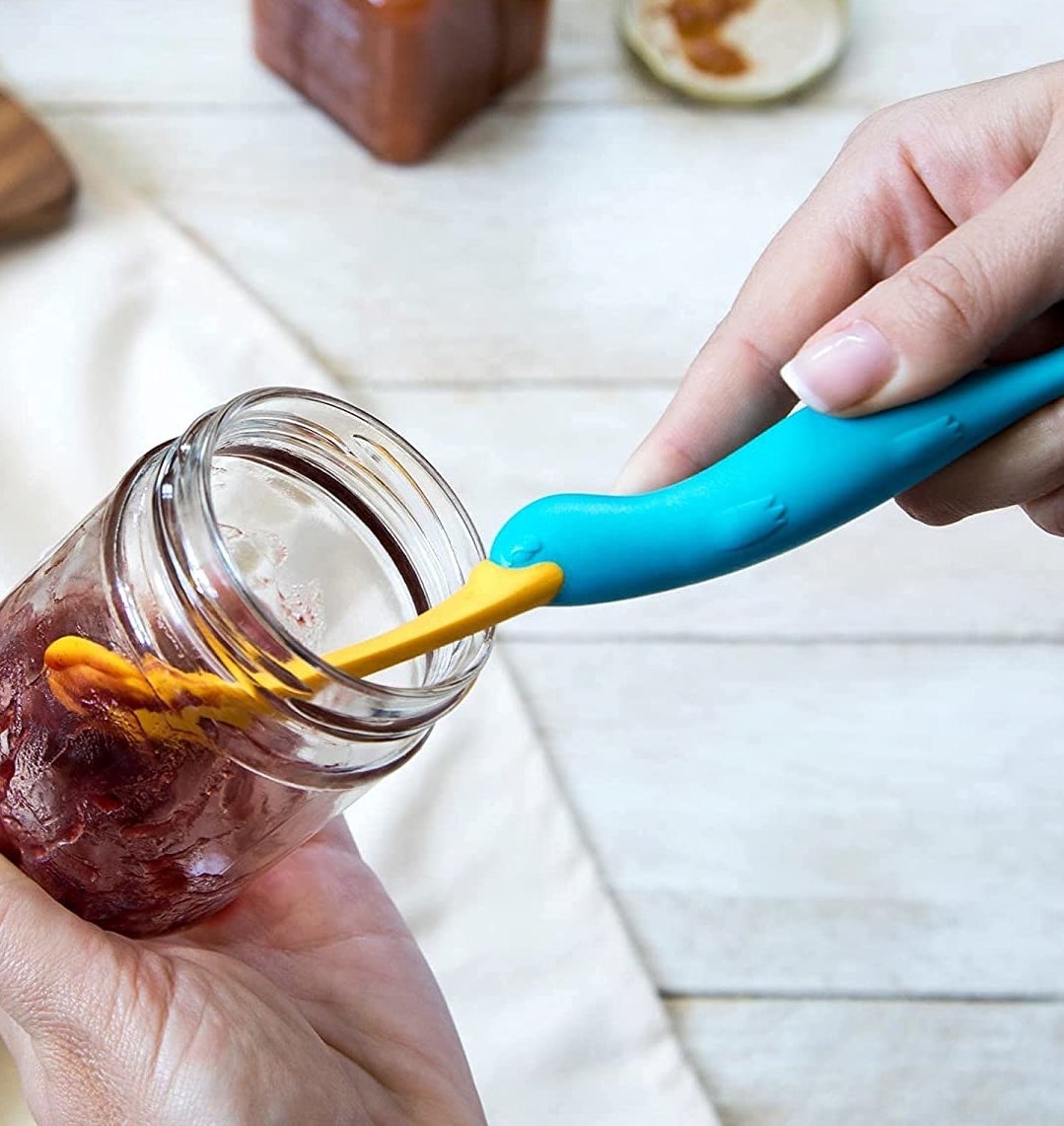 a person using the jar spatula for jam