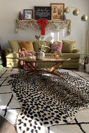 the rug stacked over another patterned rug in maximalist reviewer's room