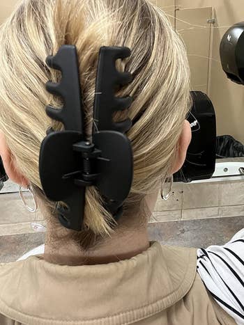 image of the black hair clip holding up a reviewer's hair