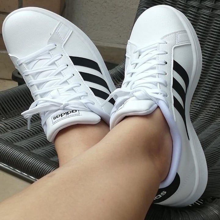 close up of reviewer wearing the white and black sneakers
