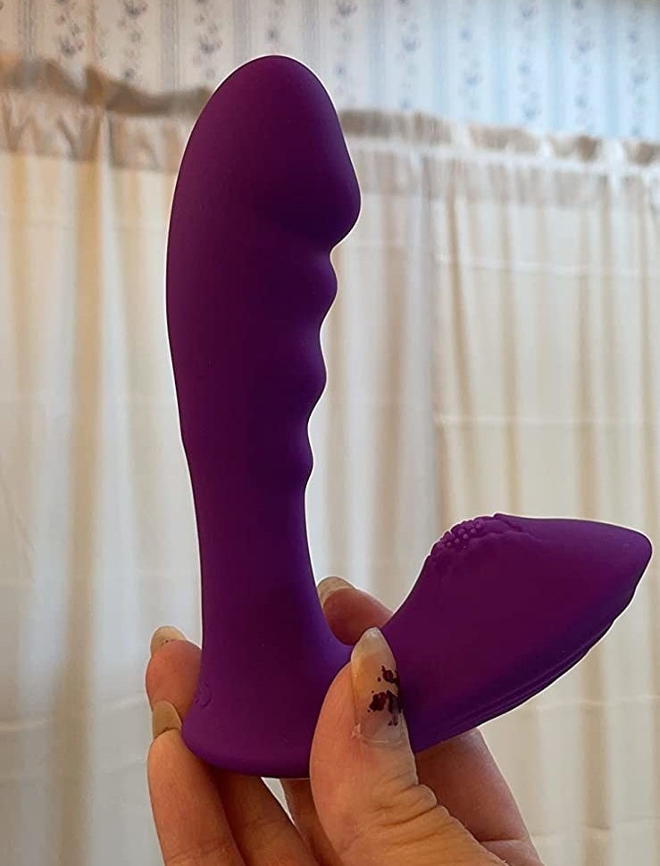 Reviewer holding purple wearable g-spot vibrator