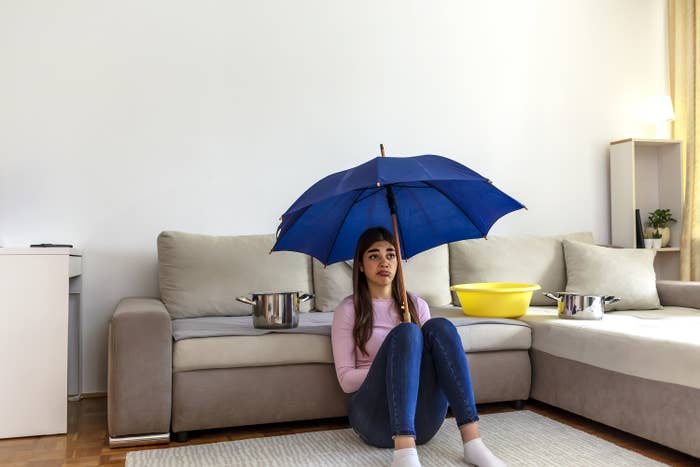 woman sitting under an umbrella in her living room