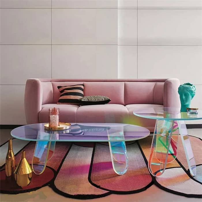 iridescent oval table with matching side table in colorful and plush decorated room