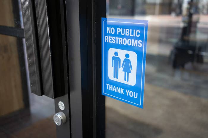 No Public Restrooms storefront sign at a restaurant or a retail store in a city.