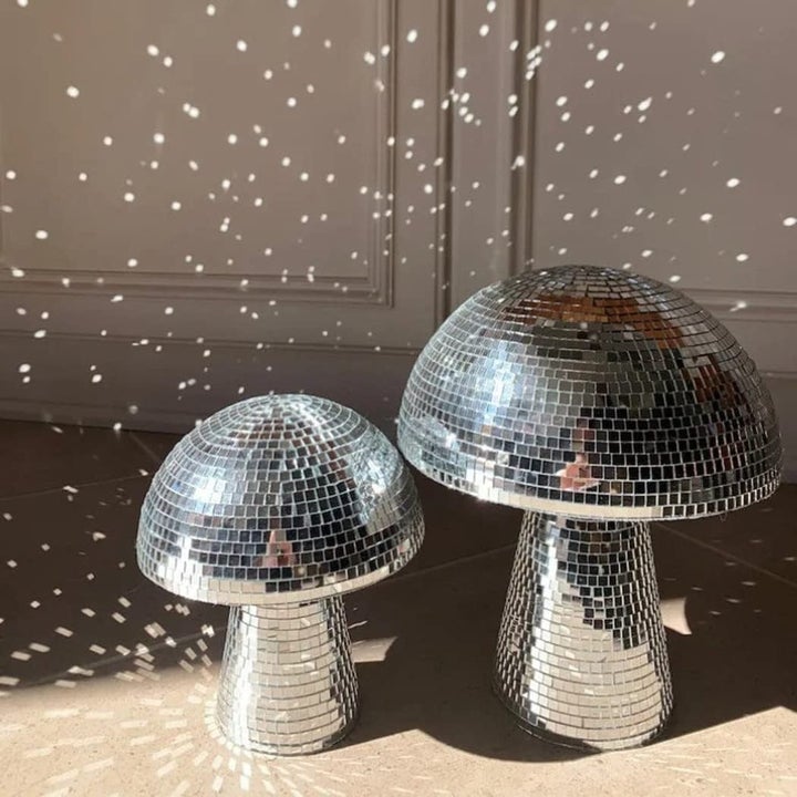 two mushroom disco balls glowing in room