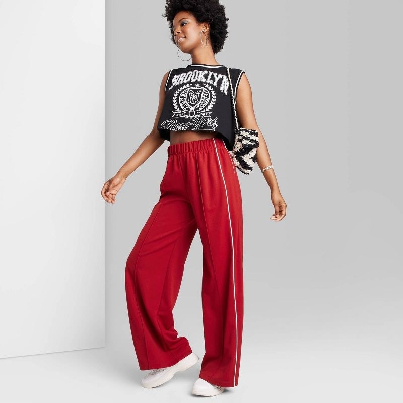 model wearing the track pants in red