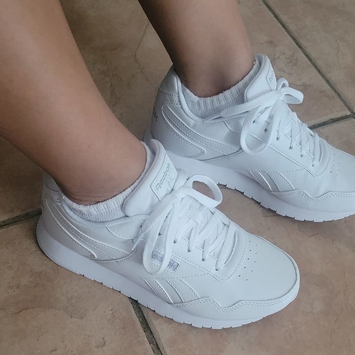 reviewer wearing the white sneakers with white socks