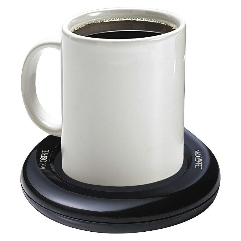 a white mug in the black mug warmer