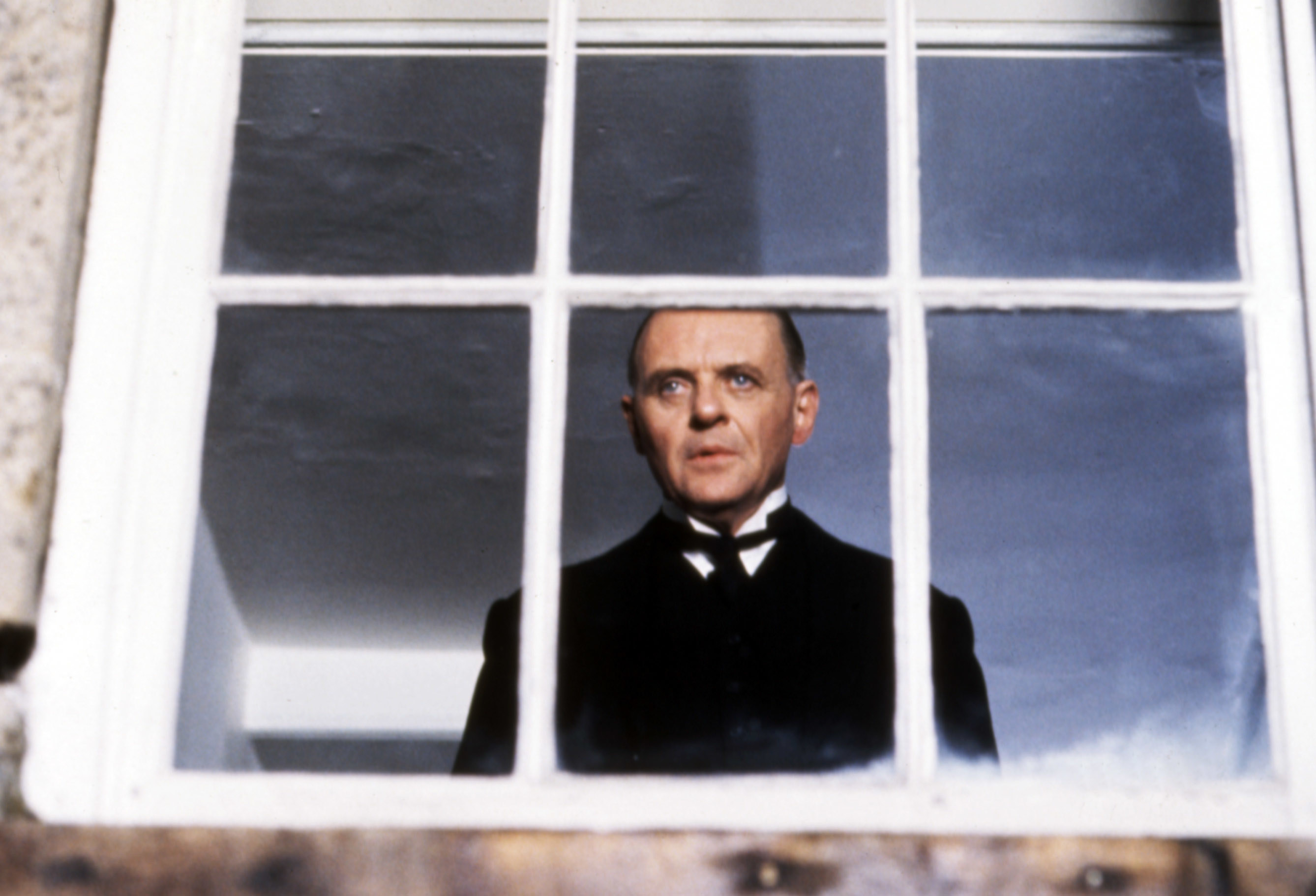 Anthony Hopkins looks out a window