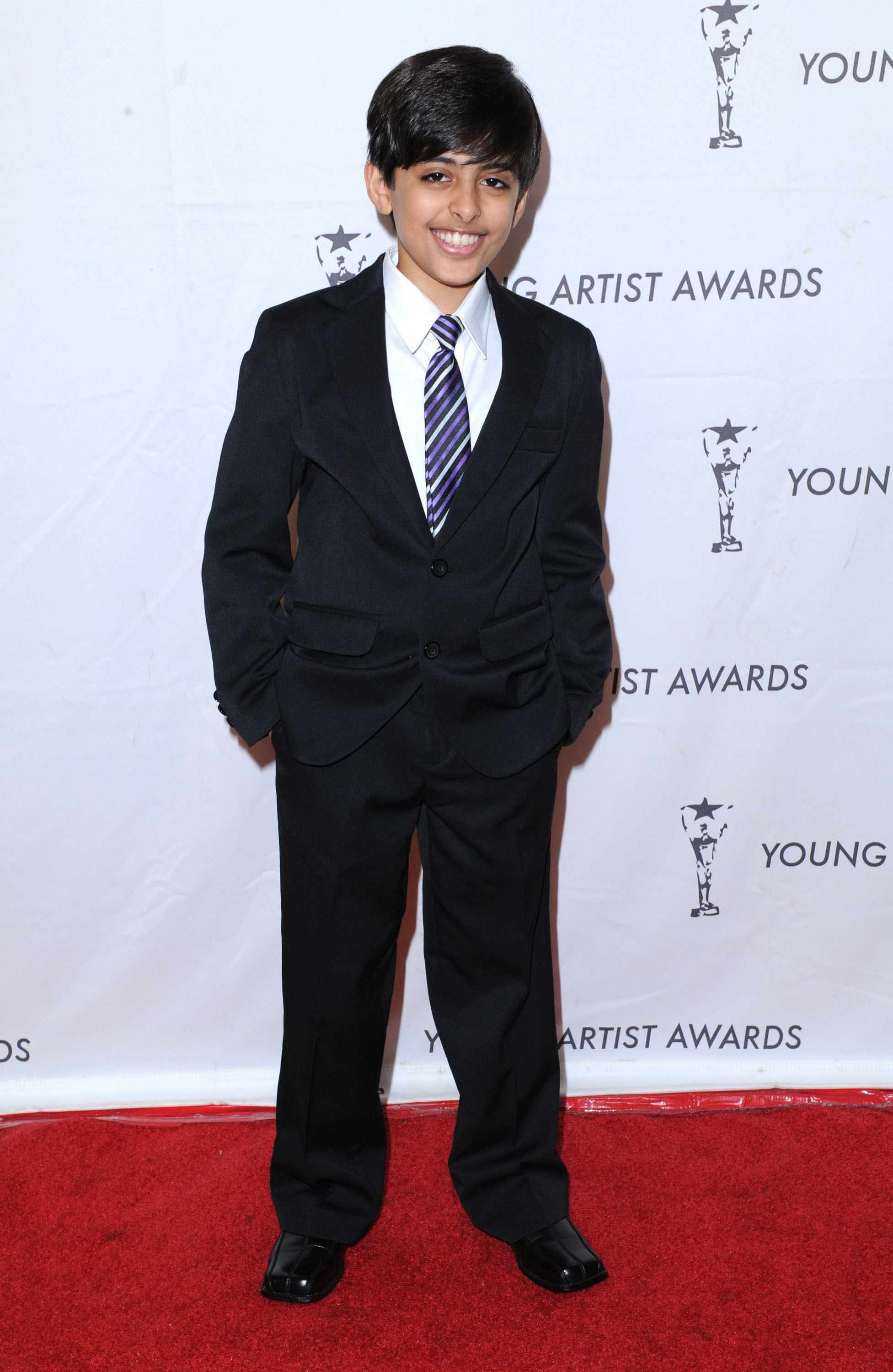 Young Karan on the red carpet in a suit