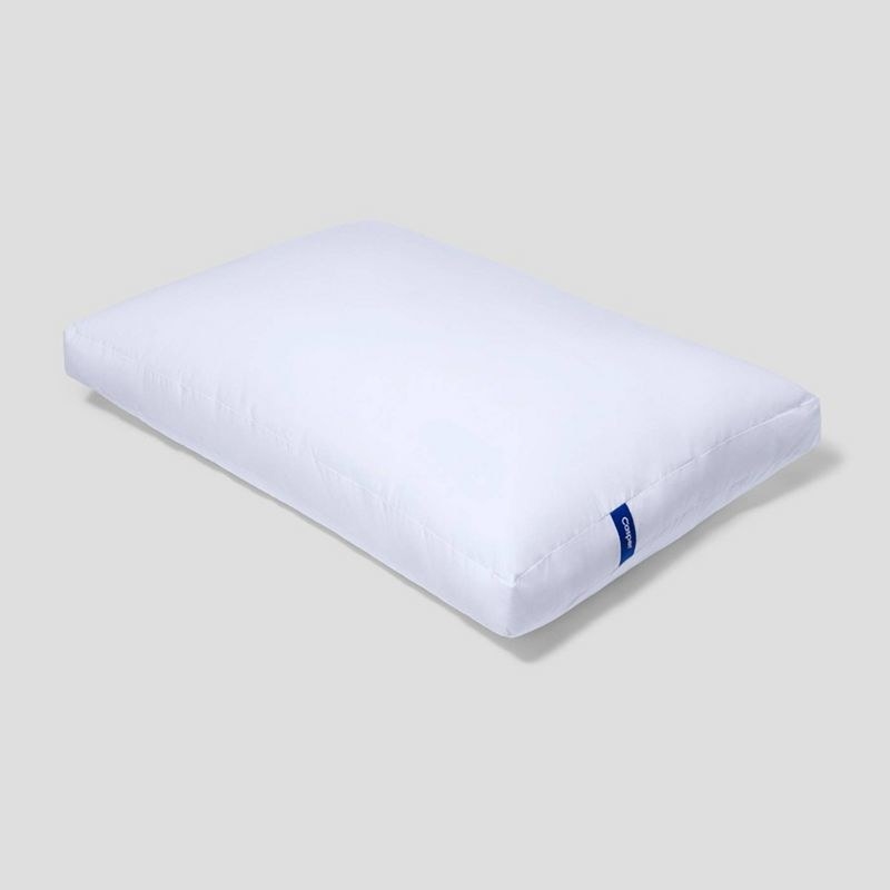 the white pillow with a small blue tag