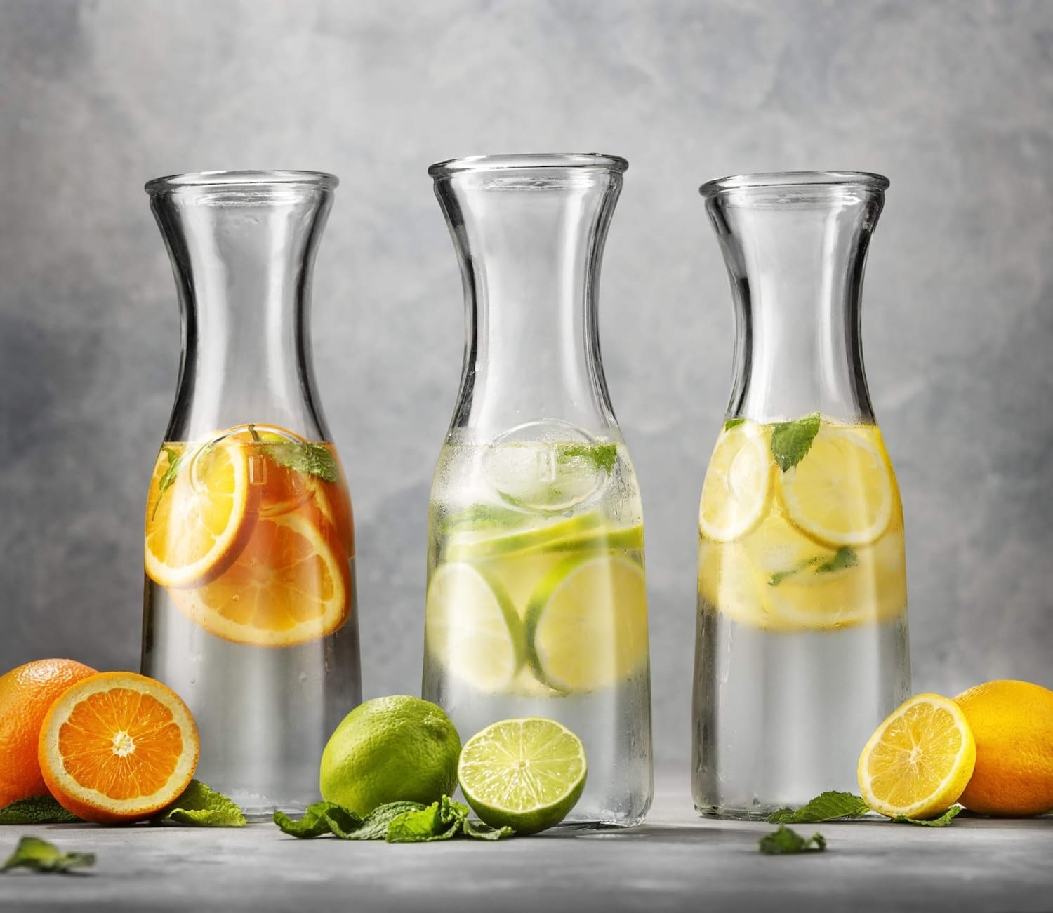 a product shot of the three carafes with fruit water inside