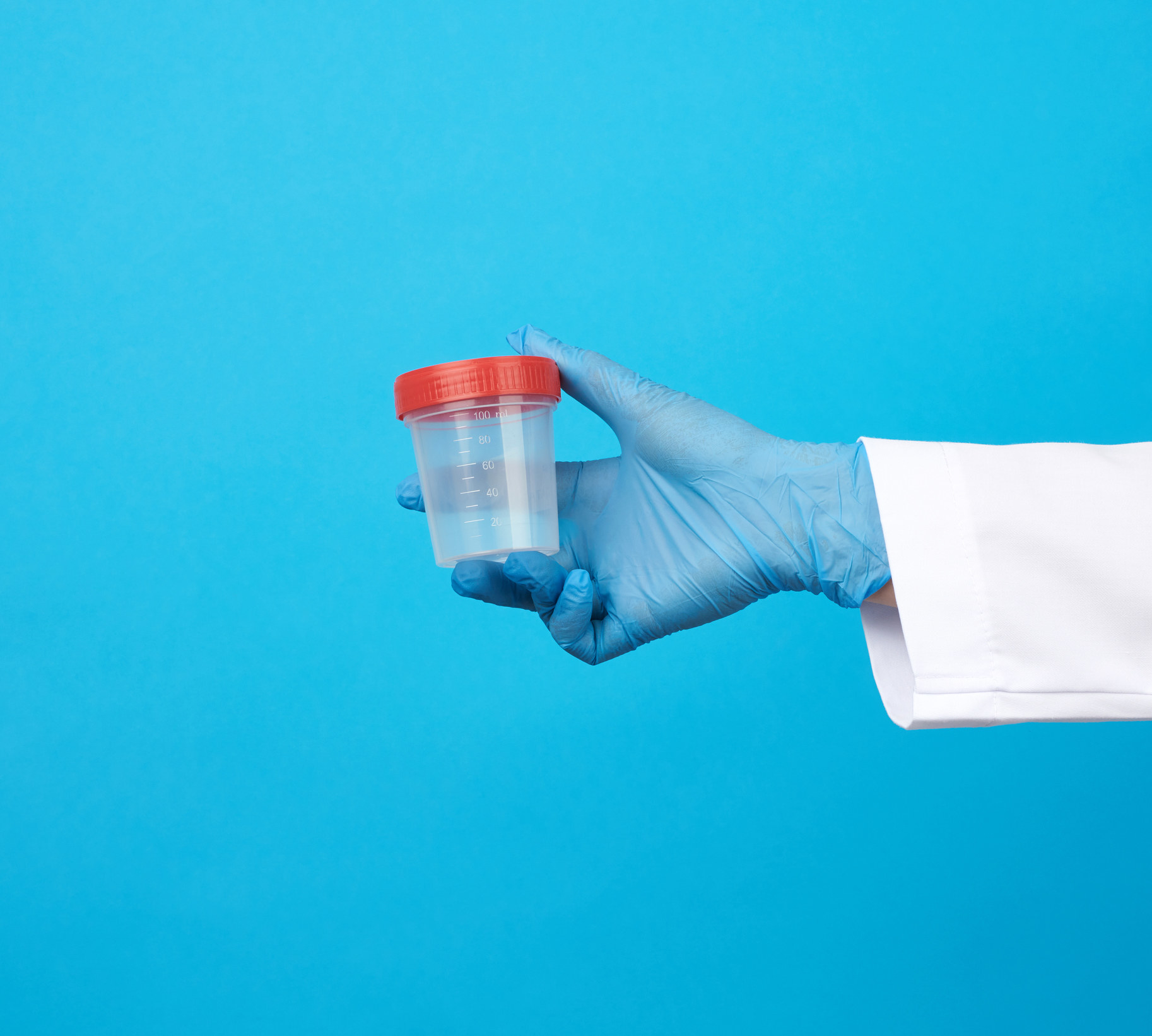 Stock image of a gloved hand holding a drug testing kit