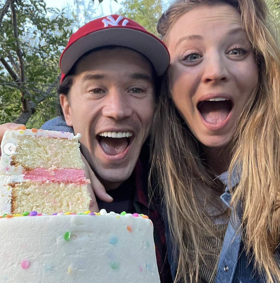 Tom and Kaley with a cake that has pink icing on the inside