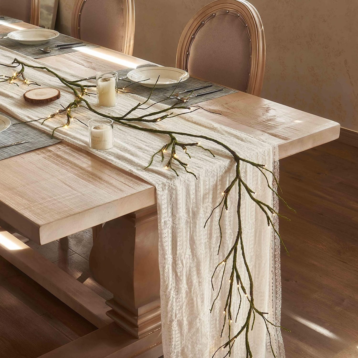 branch with led lights on the tips used as a centerpiece on table runner