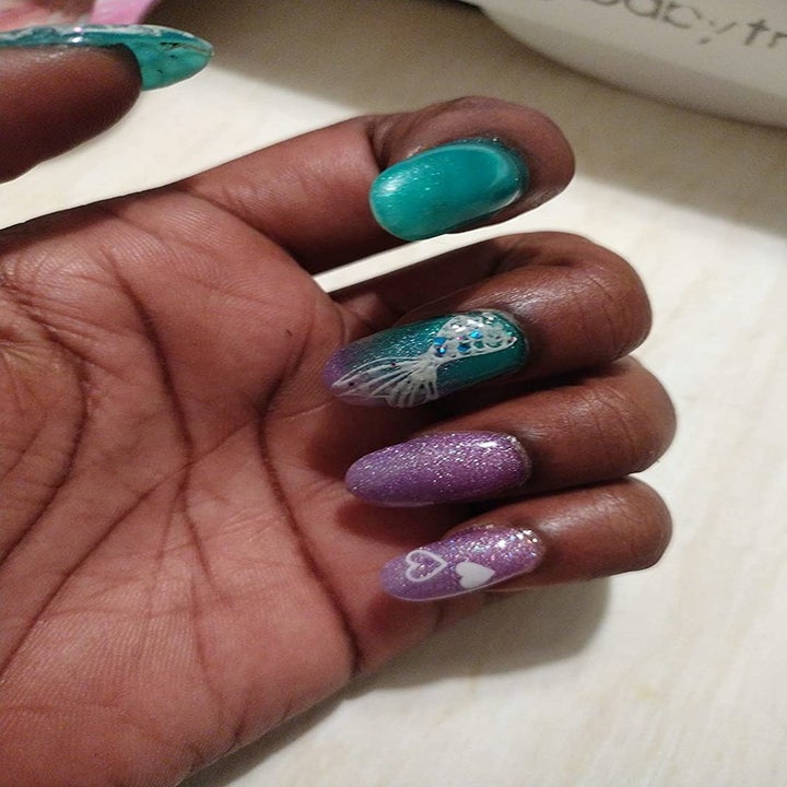 reviewer with teal and purple glitter mermaid nails