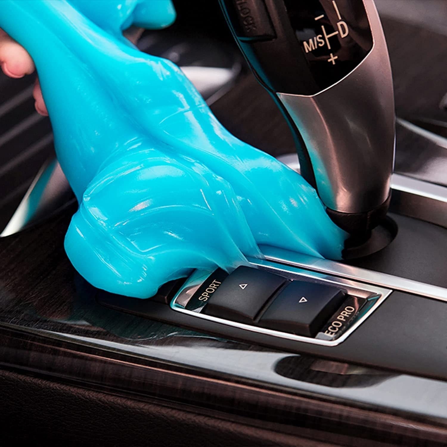 Model pulling blue gel off black car console