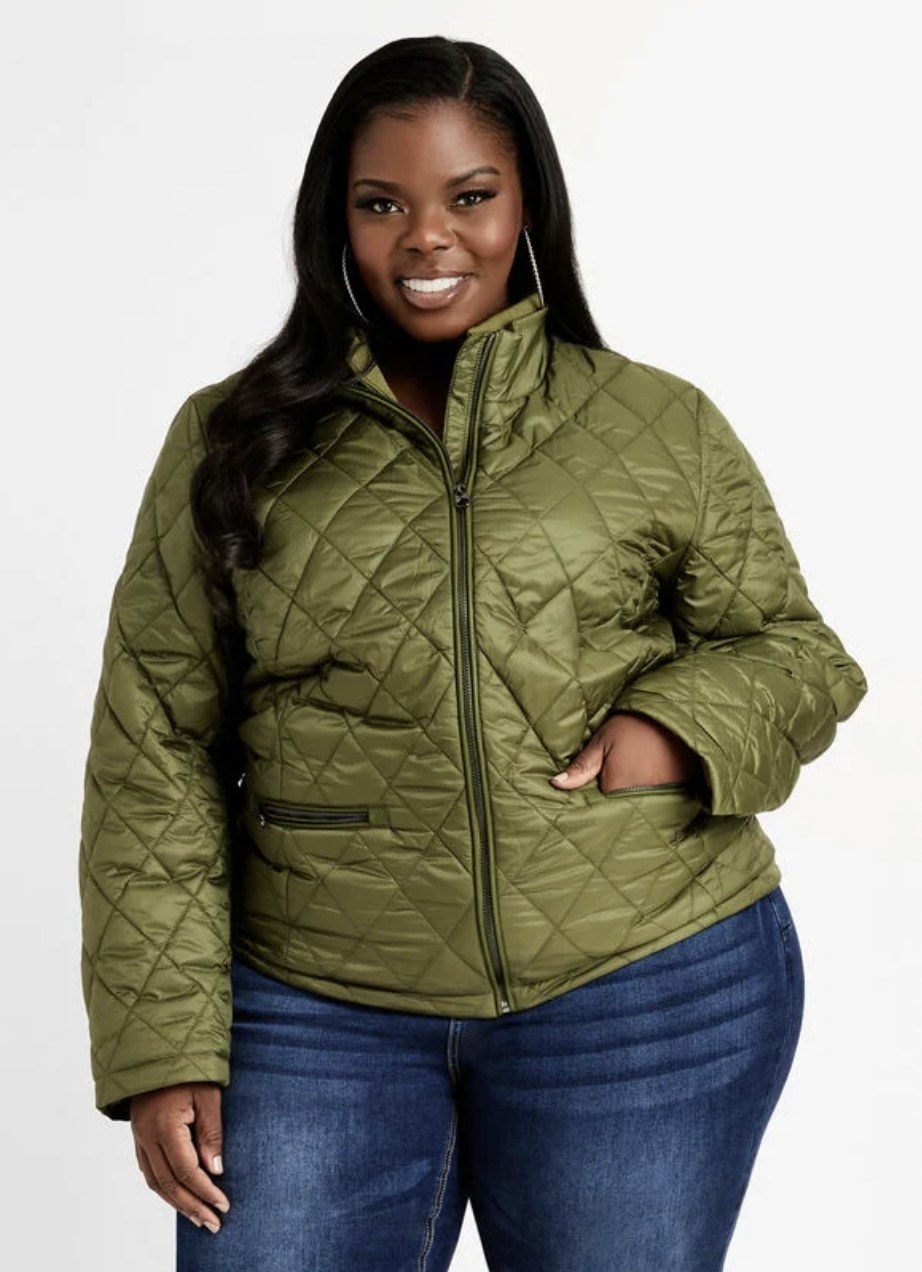 Model in the green zip-up jacket with left hand in front pocket