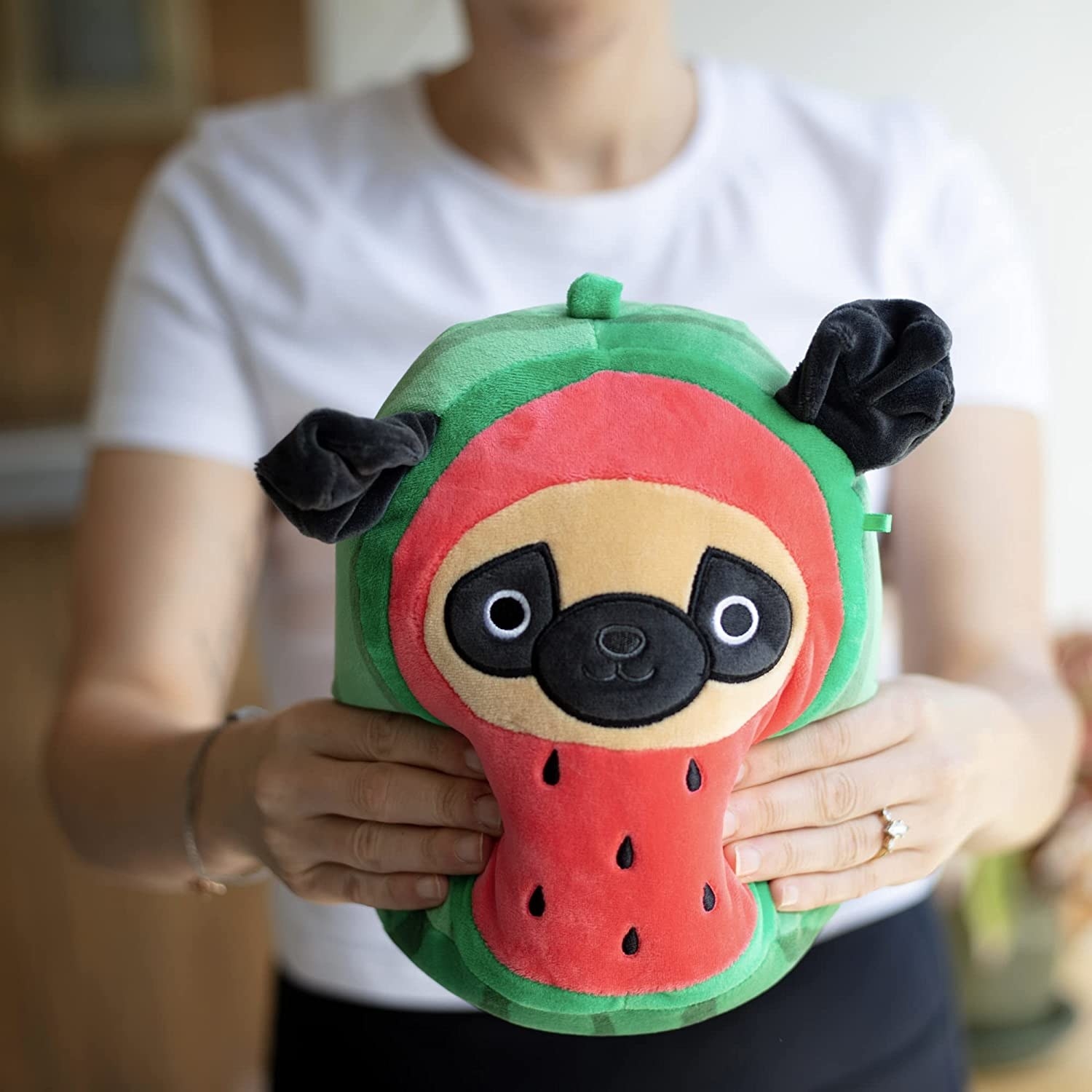 a squishmallow that&#x27;s a pug dressed as a watermelon
