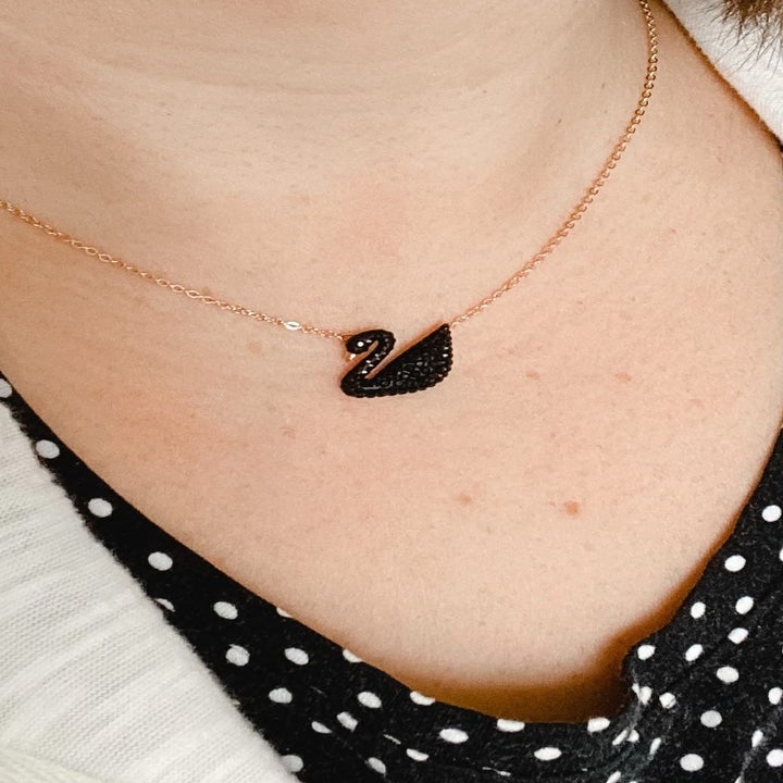 Image of reviewer wearing black swan necklace