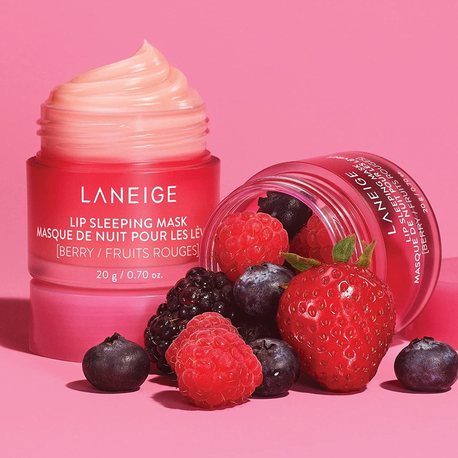 the laneige lip sleeping mask in a pink jar next to assorted berries