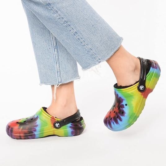 The tie dye crocs on a model&#x27;s feet