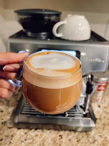 a reviewer holding a latte