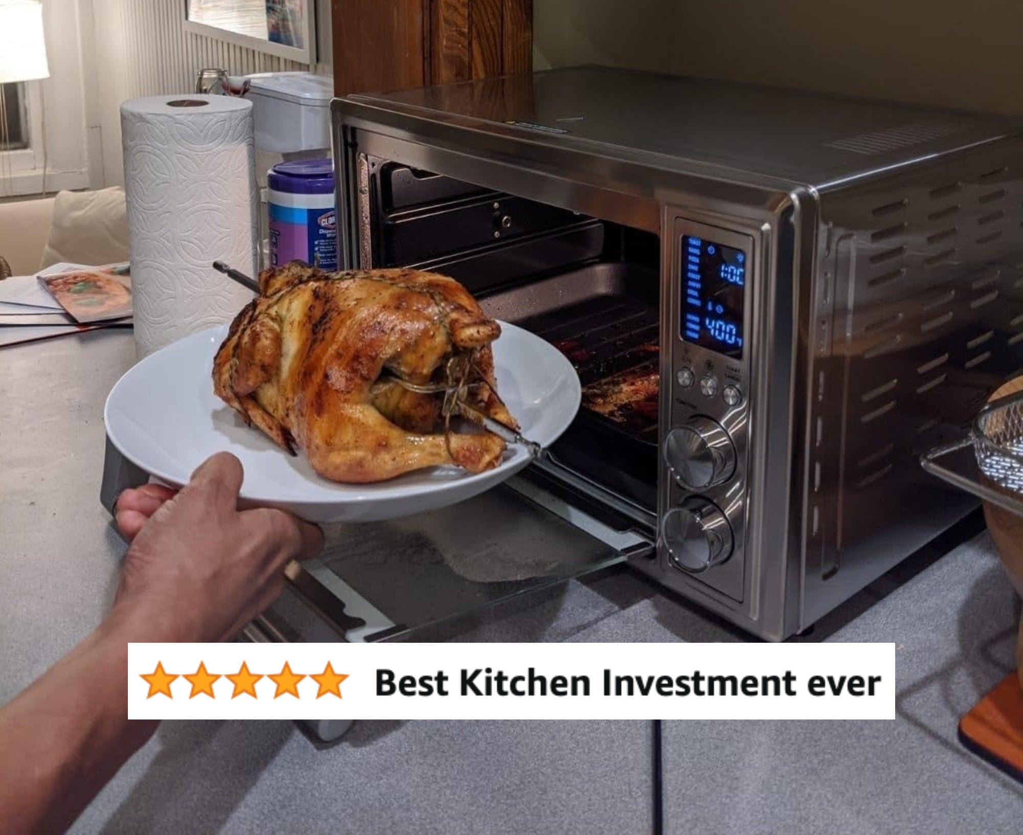 A reviewer&#x27;s air fryer with a whole cooked chicken