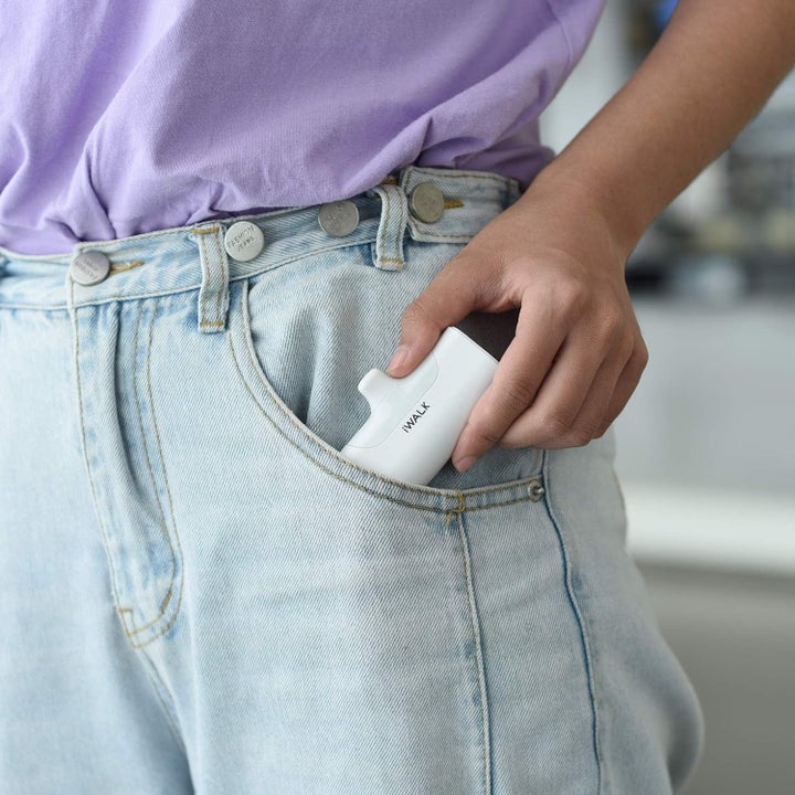 model putting the power bank in their pocket
