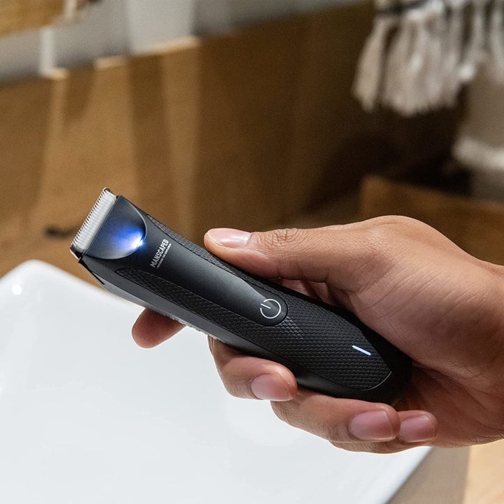 Model holding Manscaped trimmer