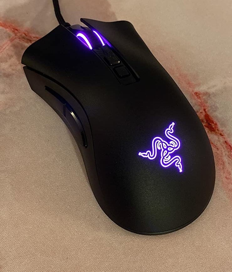the black mouse with the razor symbol glowing purple