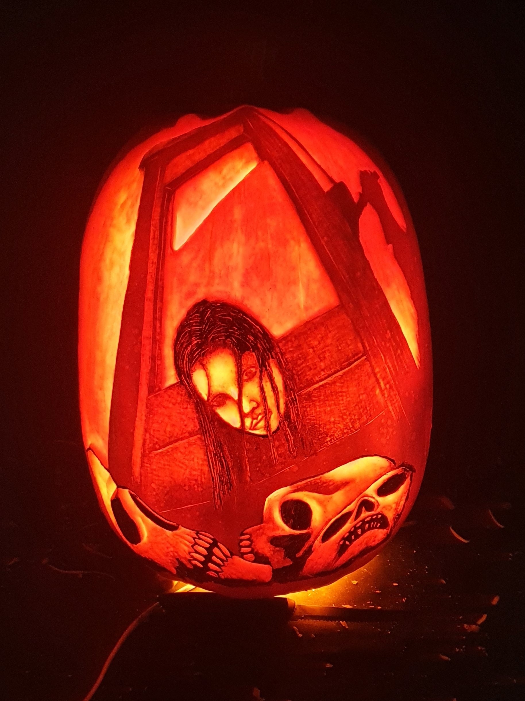 A woman at a guillotine carved on a pumpkin